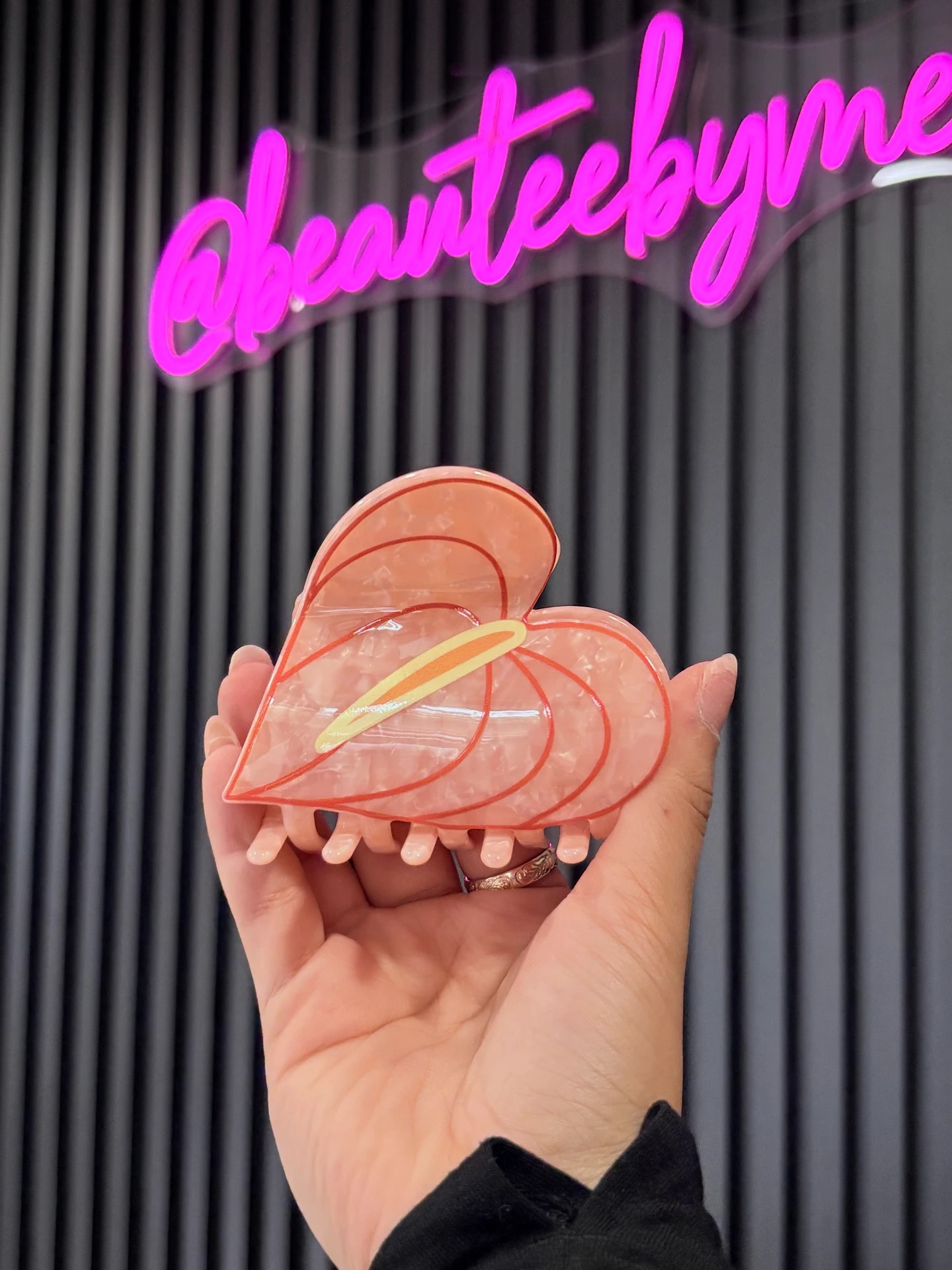 Peach Anthurium Infinity Clip held in hand