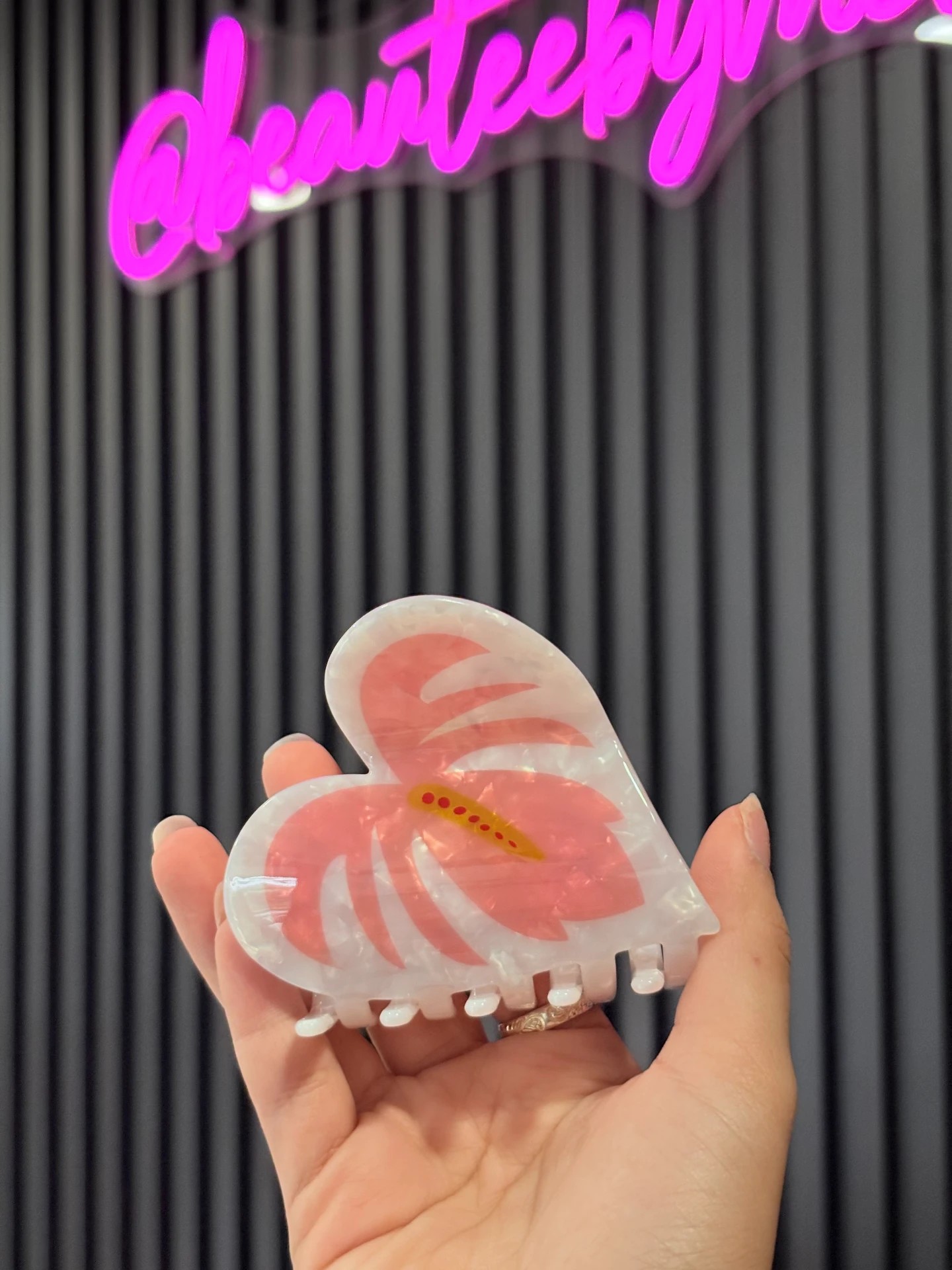 Pearl Pink Hibiscus Infinity Clip held in hand
